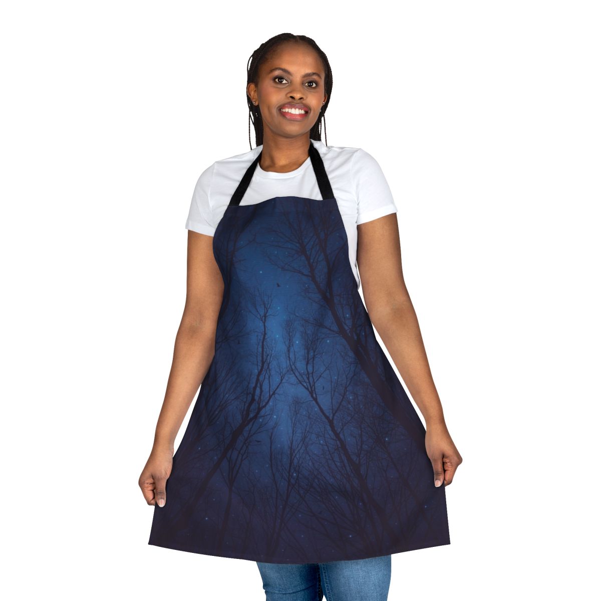 An abstract tree silhouette design against a dark, starry night sky and galaxy print background on an apron.