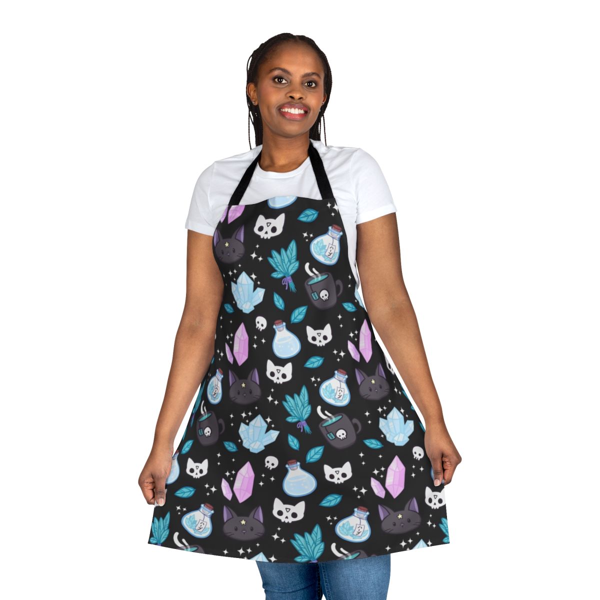 Stylish black apron featuring a whimsical cat skull and floral pattern, perfect for the modern witch or pagan