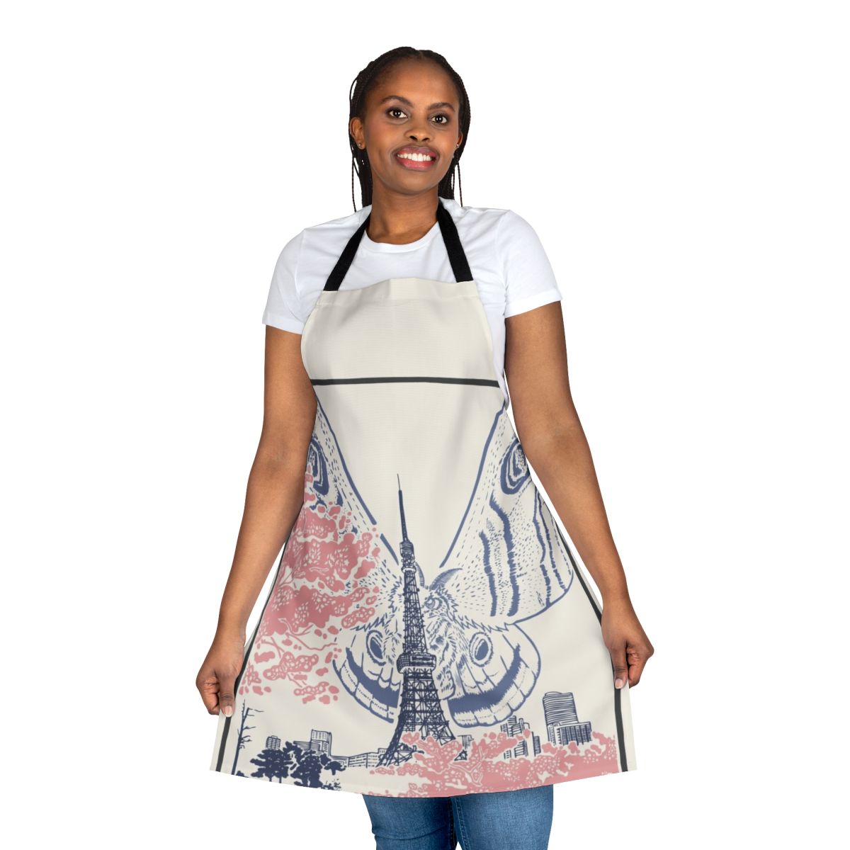 An apron featuring a giant moth creature perched on the iconic Tokyo Tower against a Japanese city skyline.