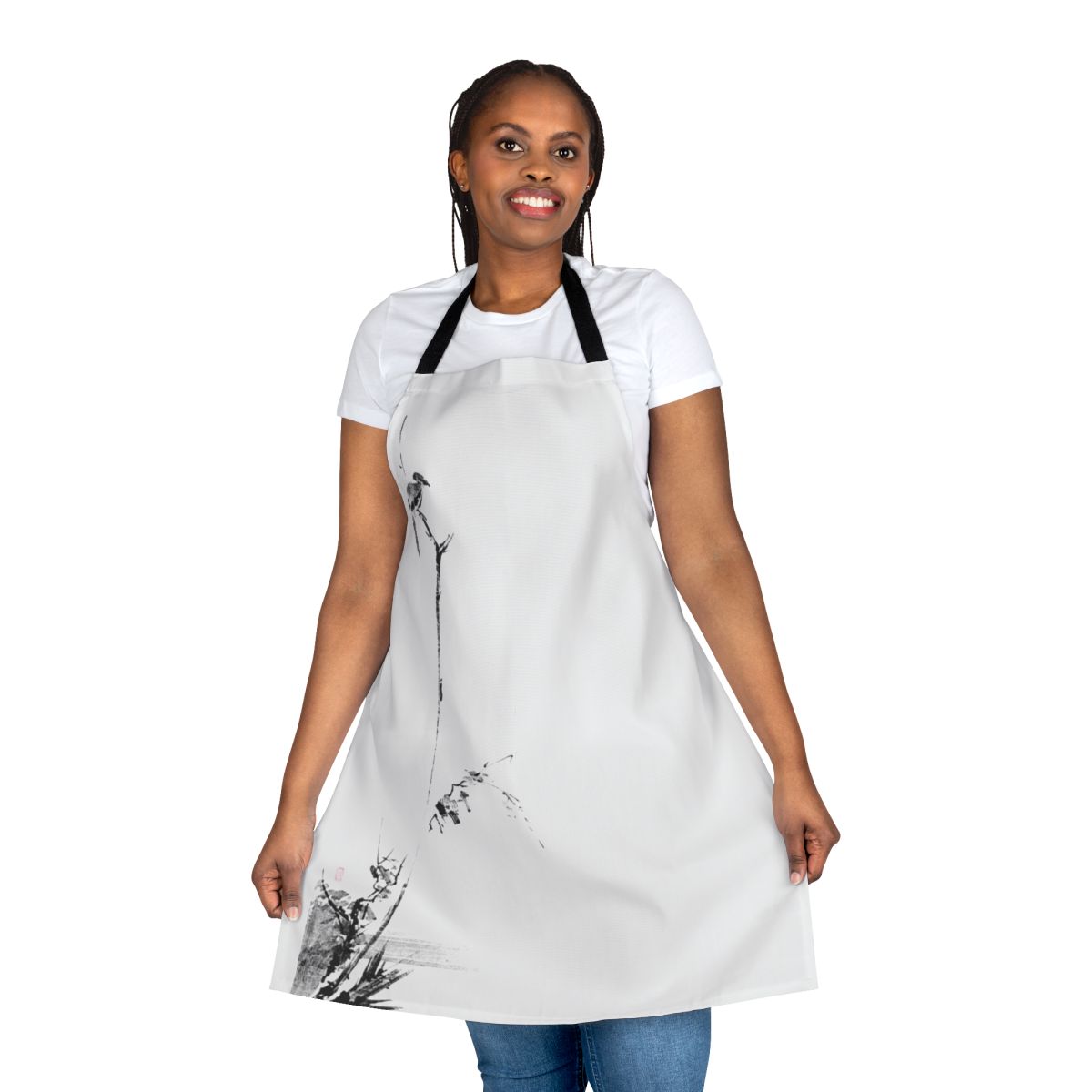A black and white apron featuring a Japanese sumi e inspired design with the name Miyamoto Musashi and elements like a shrike, katana, and Japanese calligraphy.