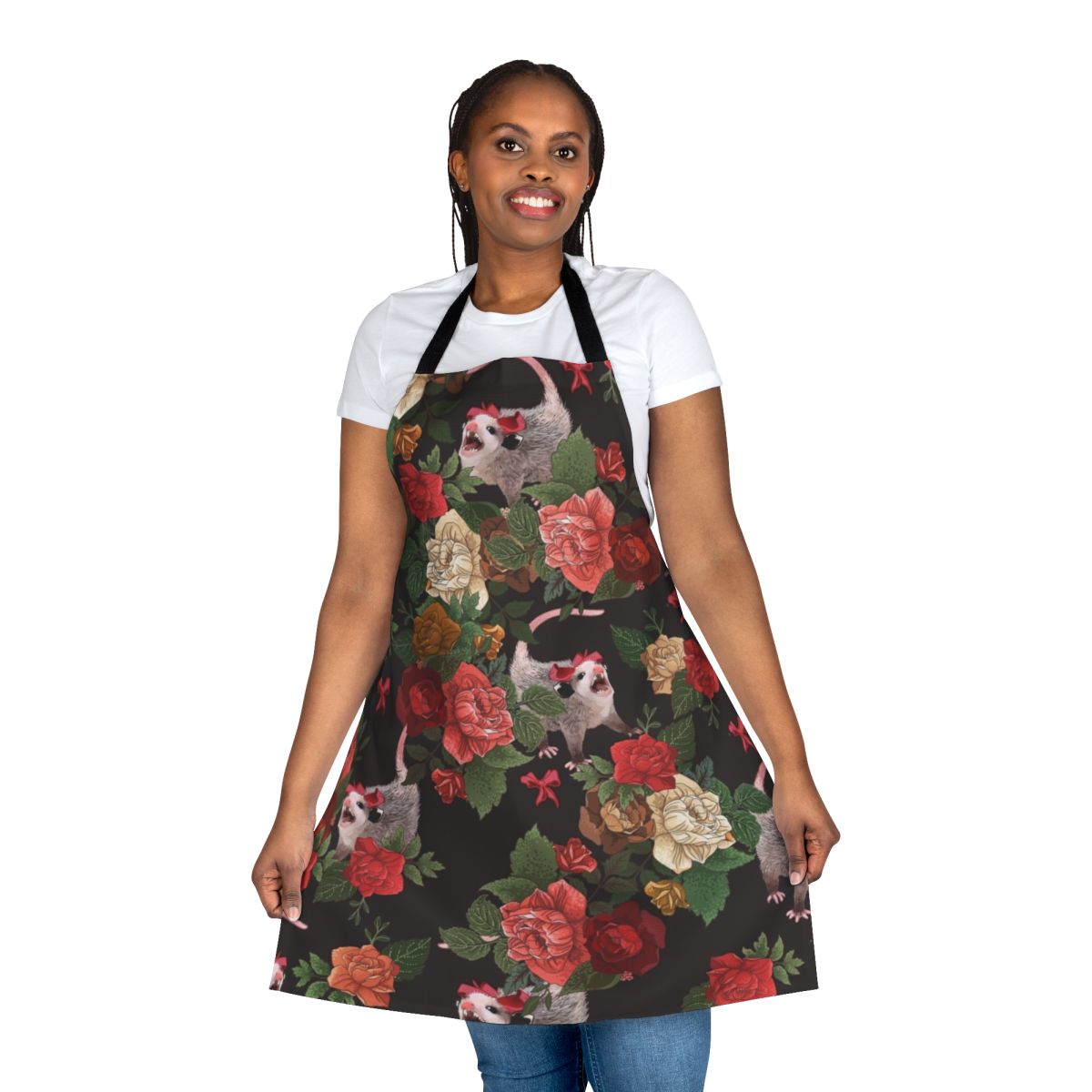 A pink and red floral apron with a repeating opossum or possum print, perfect for adding a touch of whimsy to your kitchen.
