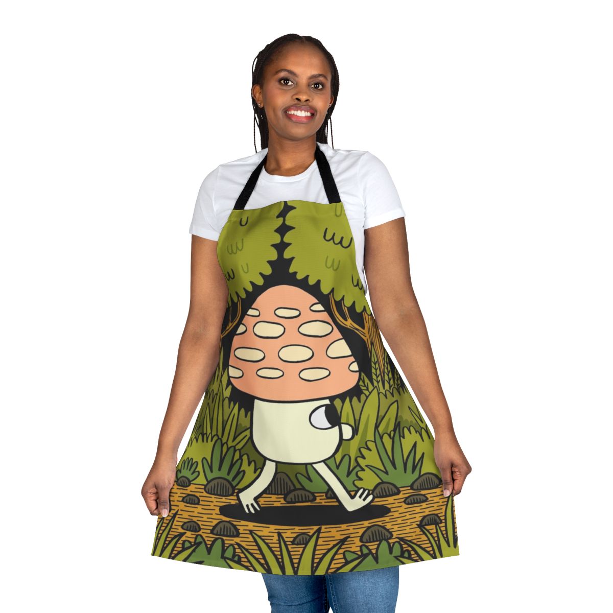 A whimsical apron featuring a woodland scene with mushrooms, leaves, and ferns in shades of green and yellow.