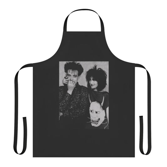 Apron featuring a stylized design with the names "Siouxsie Sioux" and "Robert Smith" against a dark background, representing 1980s alternative music.