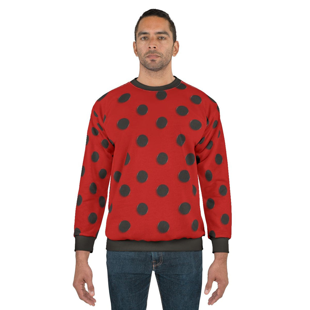 A model wearing a cozy ladybug-themed sweatshirt