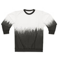 A person hiking in a foggy, forested landscape wearing a nature-inspired sweatshirt