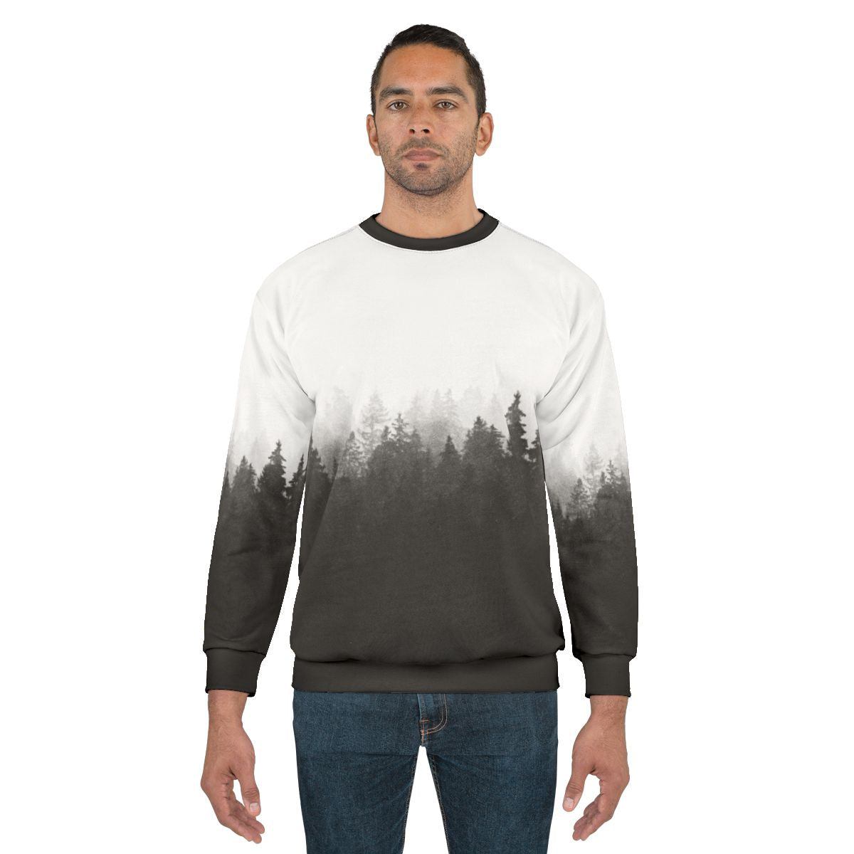 A person hiking in a foggy, forested landscape wearing a nature-inspired sweatshirt