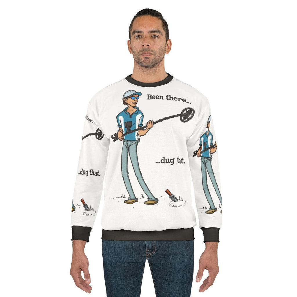Metal detecting enthusiast wearing "Been There Dug That" sweatshirt