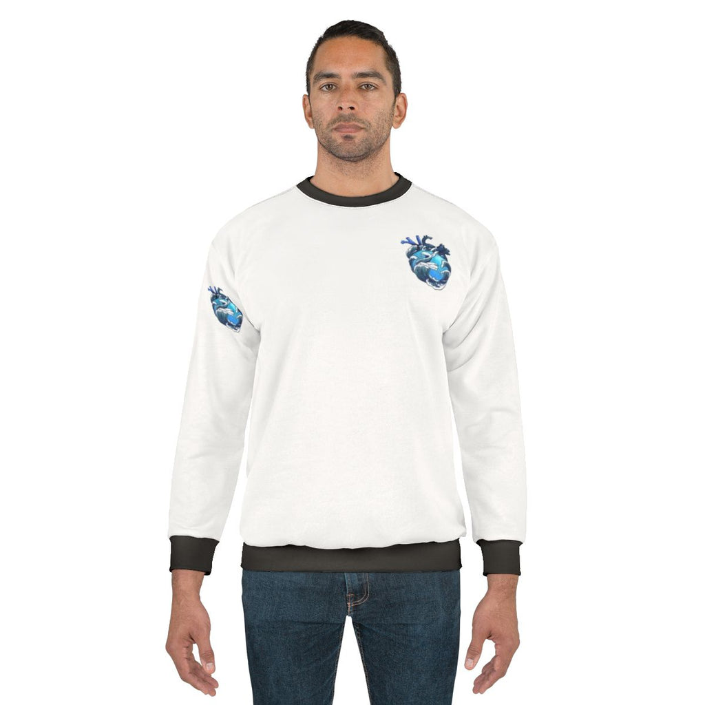 Ocean-inspired anatomical heart design on blue sweatshirt