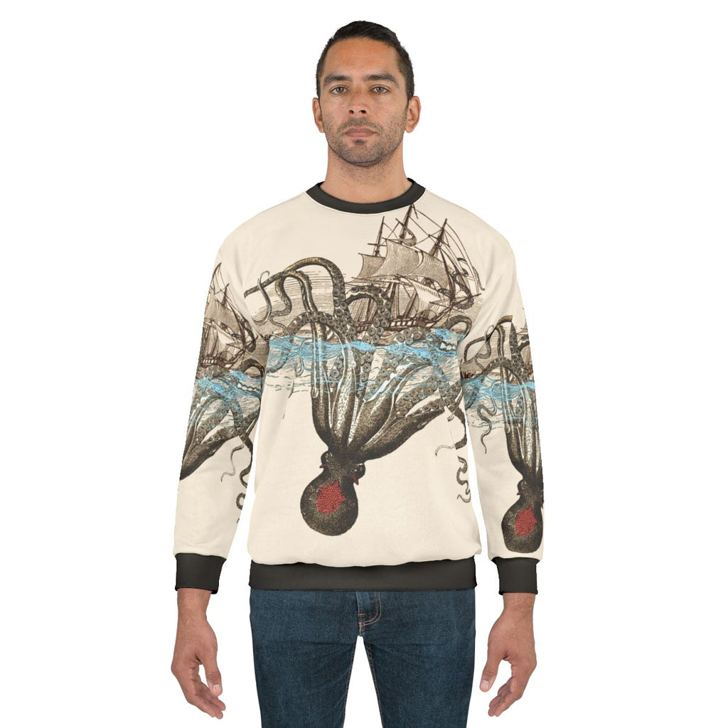 A person wearing a sweatshirt with a kraken design