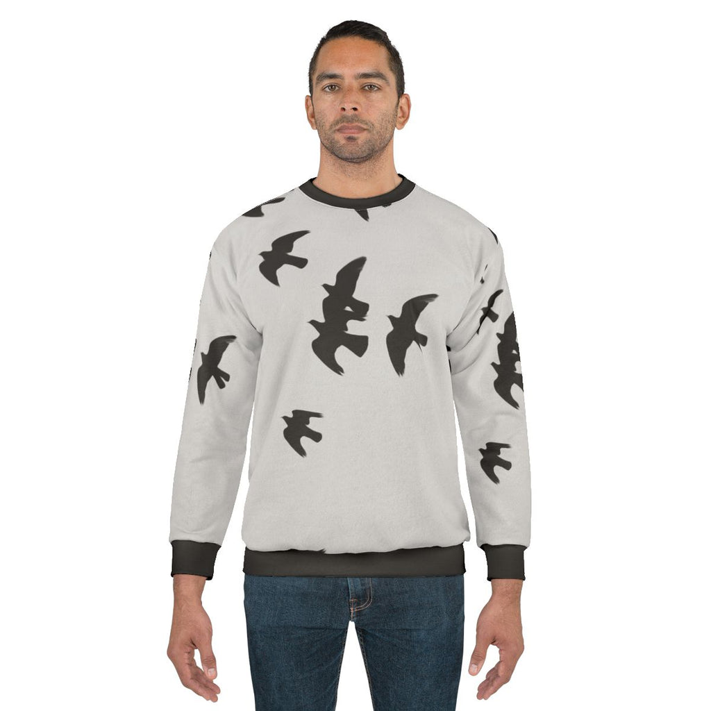 Black sweatshirt with a design of migratory birds in flight