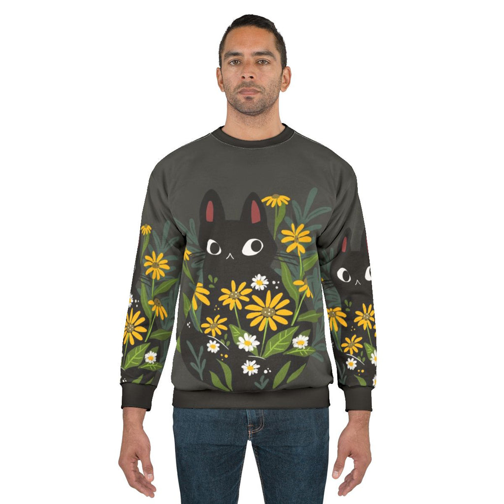 Black cat with colorful flower print on sweatshirt