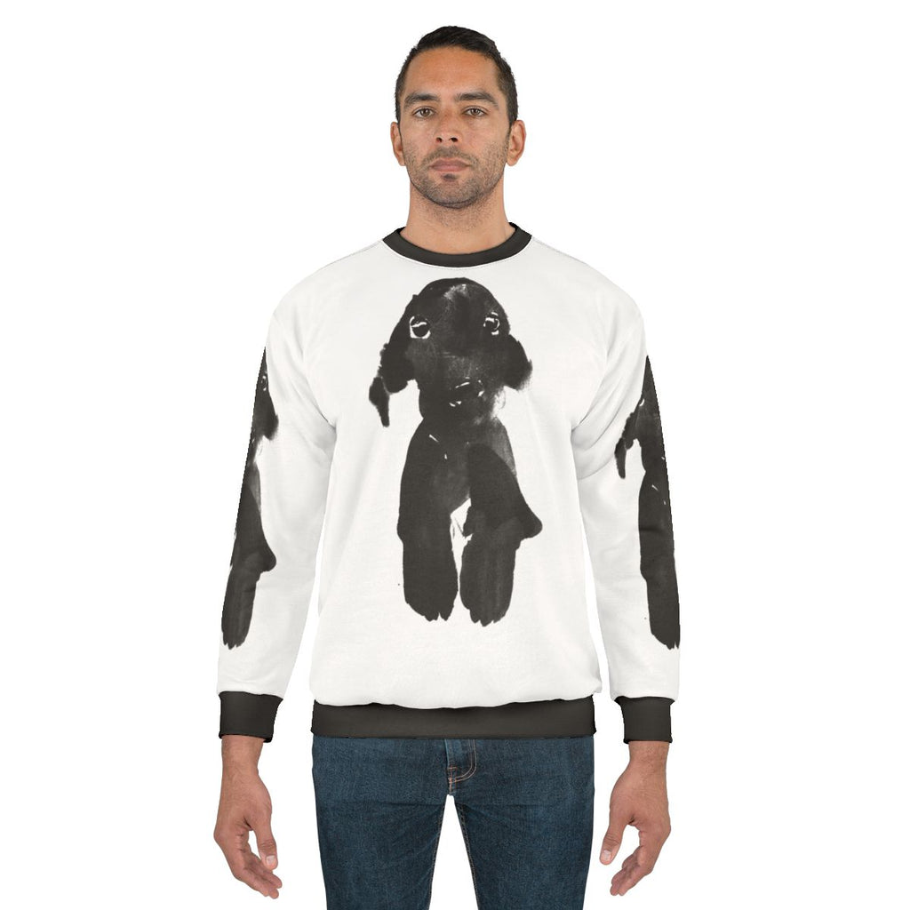 Black dog wearing a cozy sweatshirt