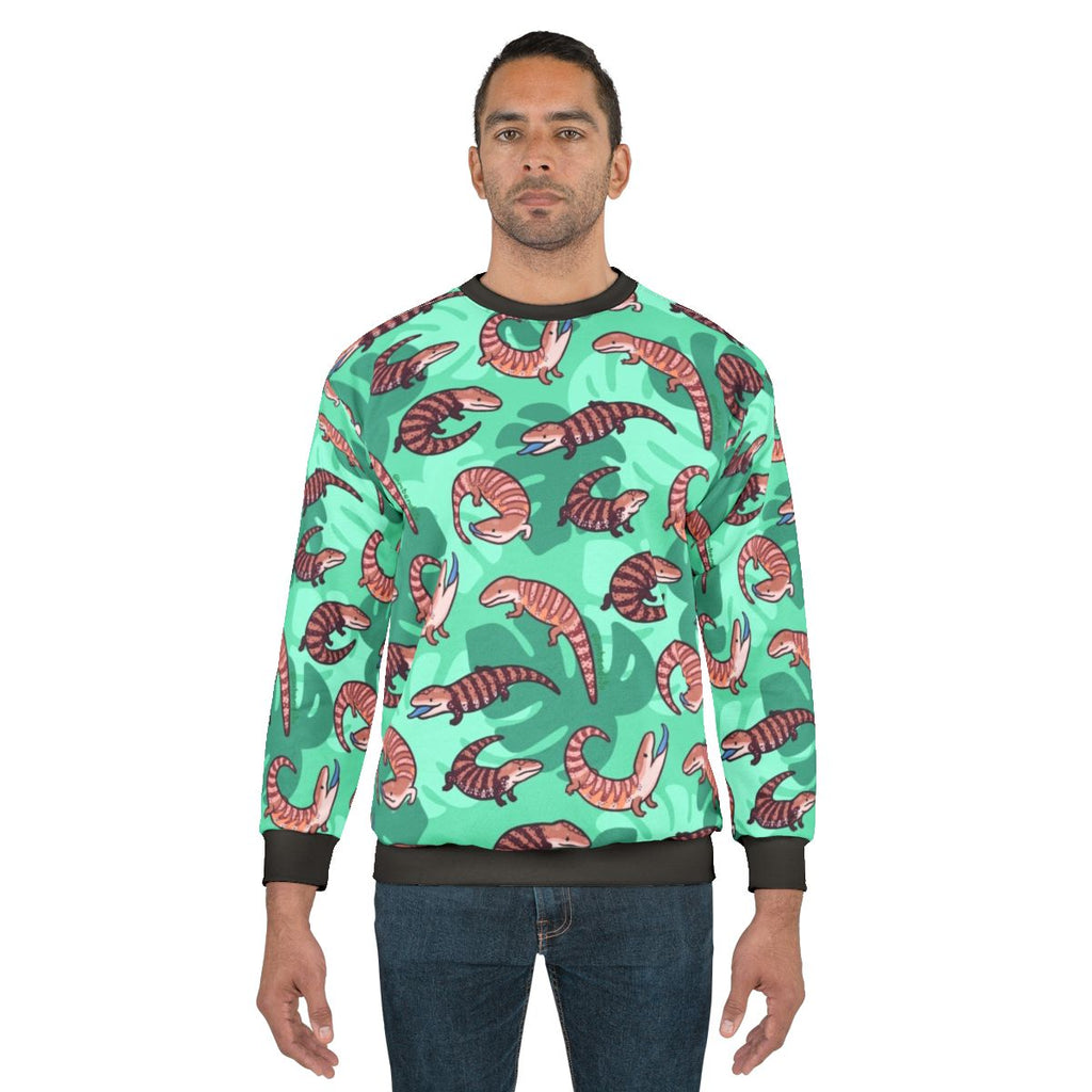 Vibrant blue tongue skink illustration on a cozy sweatshirt