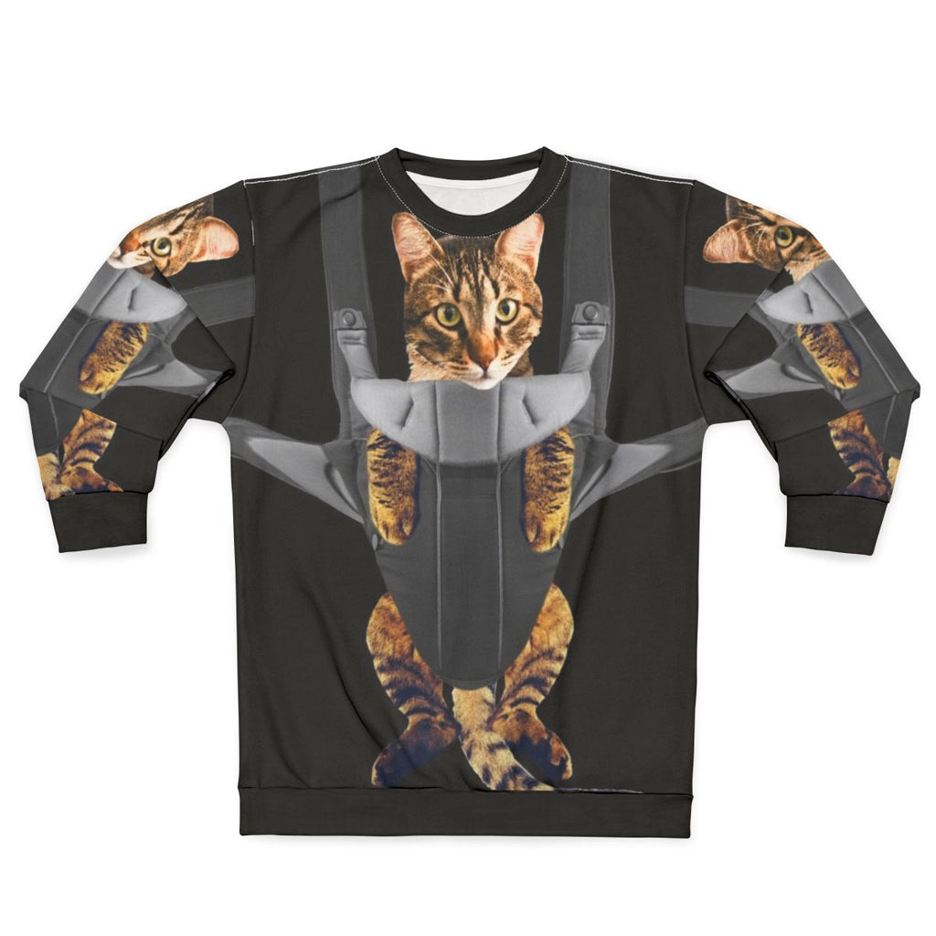 Cute tabby cat in a baby carrier on a sweatshirt