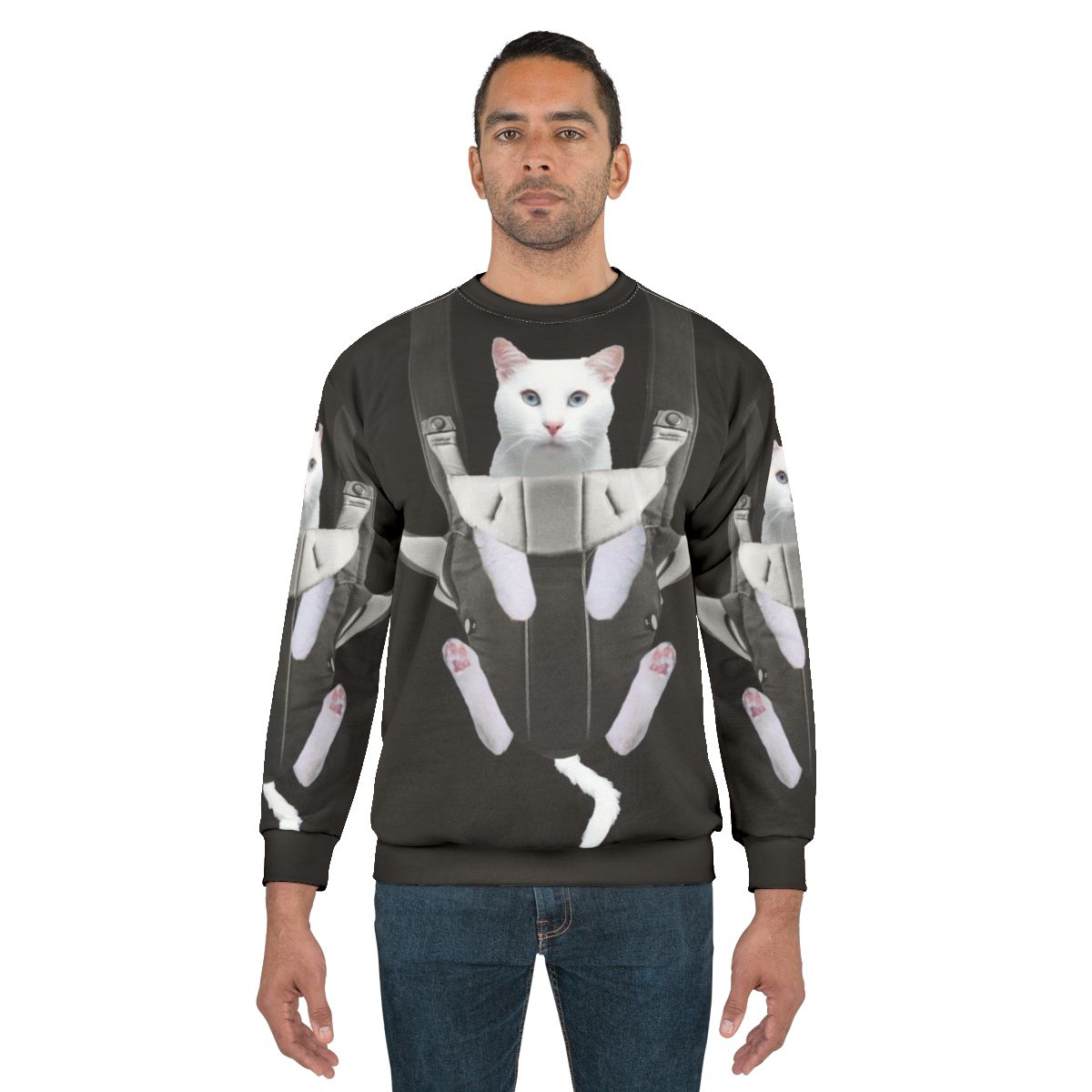 Tabby cat snuggling in a baby carrier on a white sweatshirt