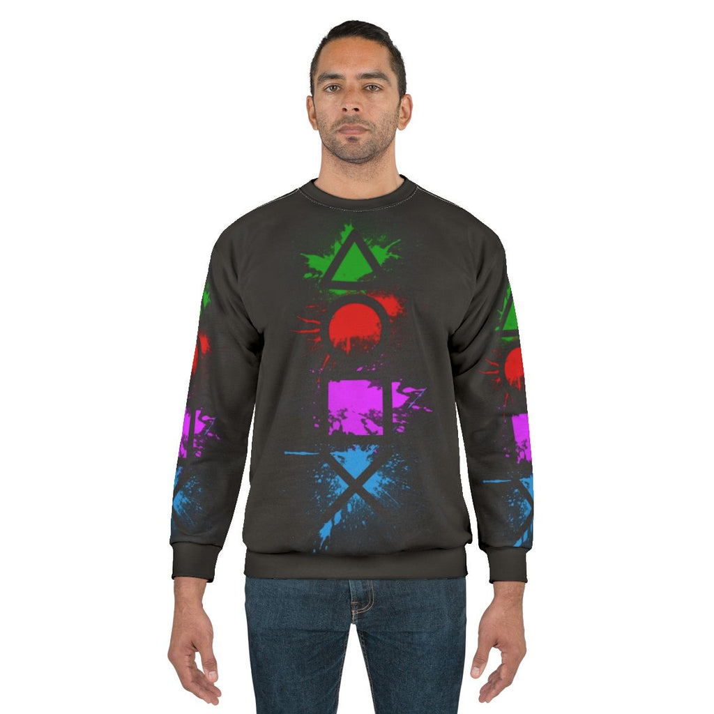 Playstation controller buttons splatter design on a cozy sweatshirt