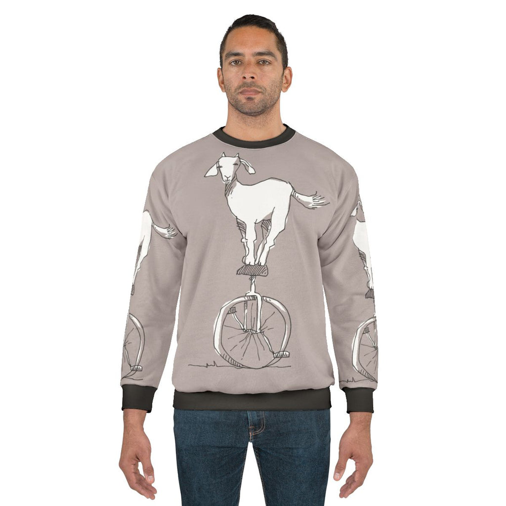 Goat on a unicycle printed on a cozy sweatshirt