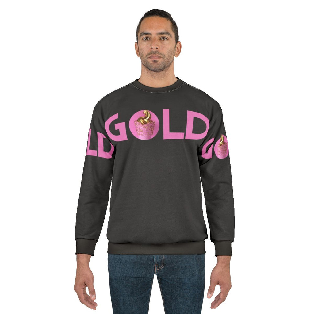 Gold and pink sweatshirt with a trendy graphic design