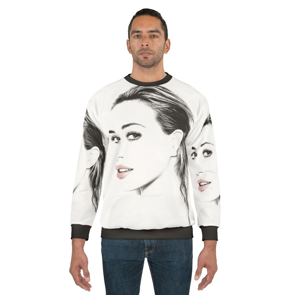 Hilary Duff wearing a gray sweatshirt with a graphic design