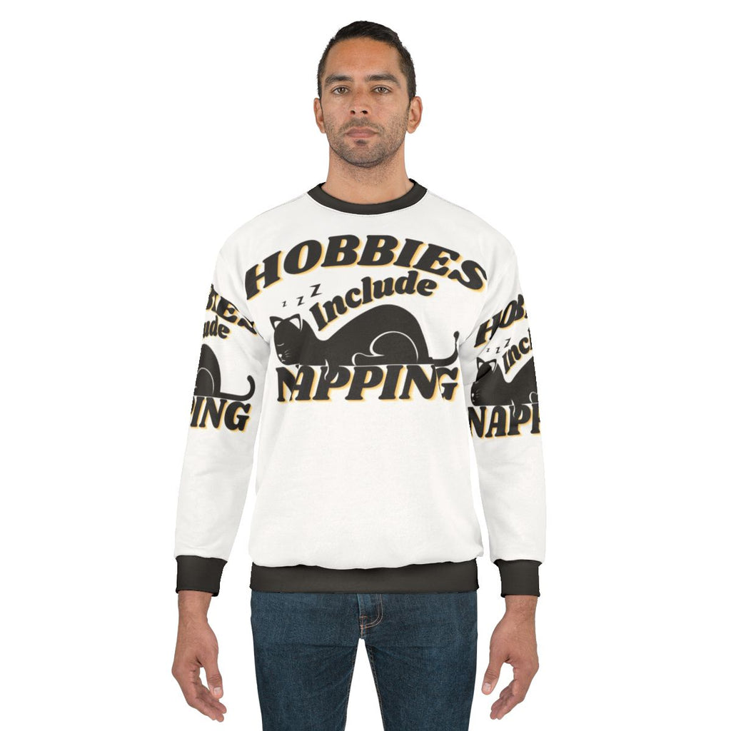Person wearing a cozy "Hobbies Include Napping" sweatshirt