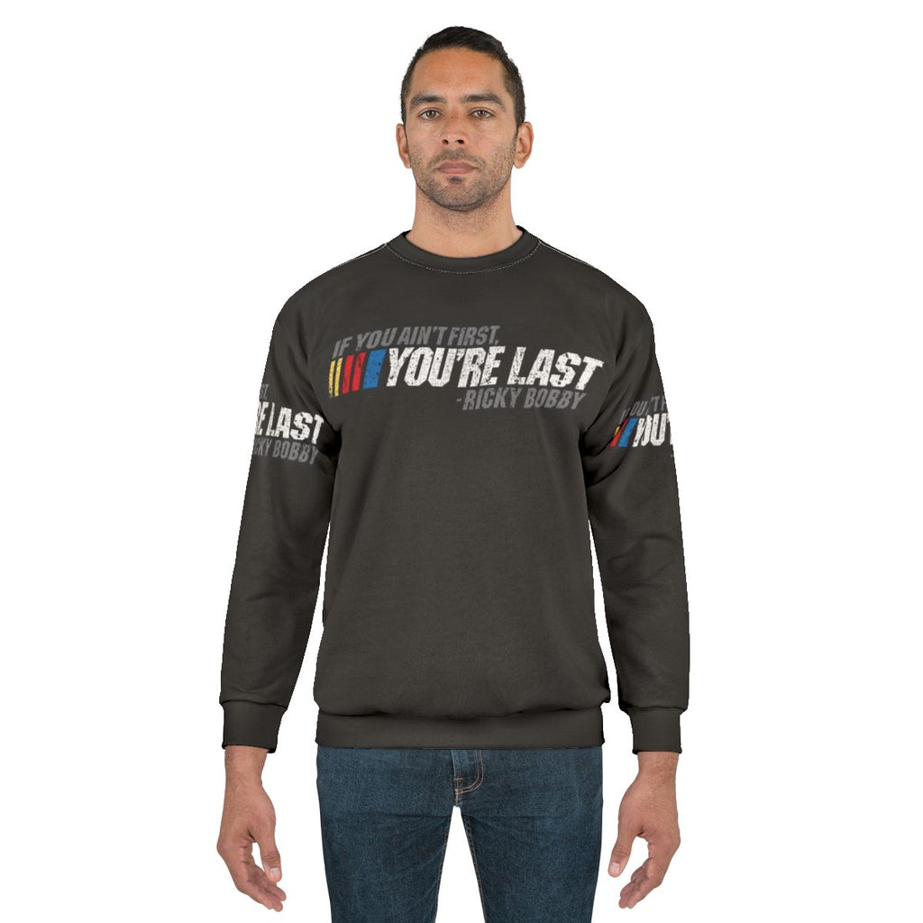 Ricky Bobby quote "If You Ain't First, You're Last" printed on a cozy sweatshirt