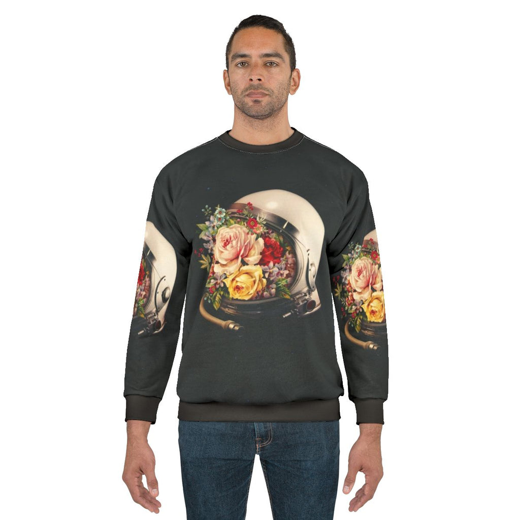 Celestial Bloom Astronaut Sweatshirt featuring a surreal collage of an astronaut, stars, and flowers