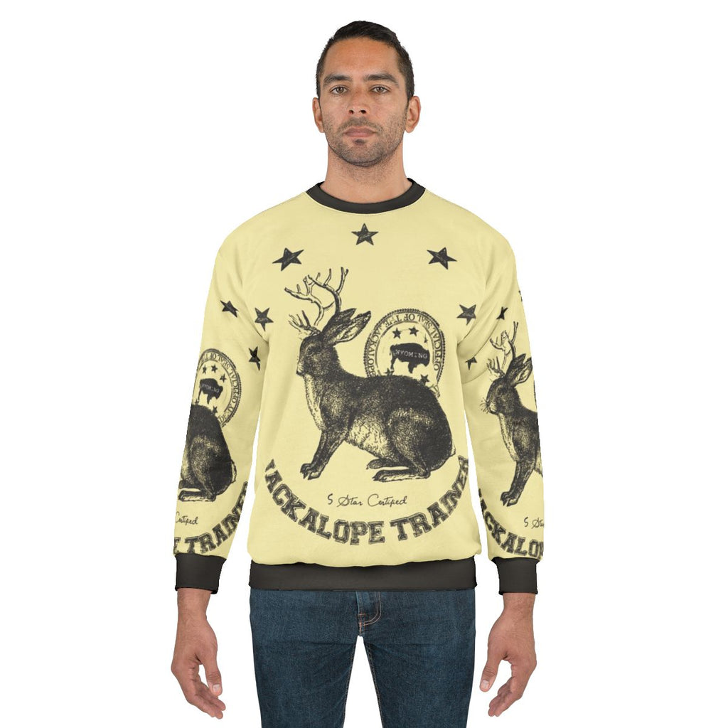 Beige sweatshirt with jackalope graphic, mythical animal trainer design