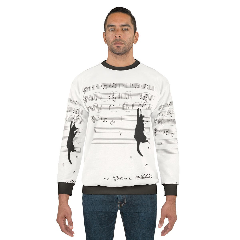 Mischievous sweatshirt with a cat playing music in a surreal composition