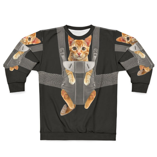 Monty the cat wearing a baby carrier on a sweatshirt