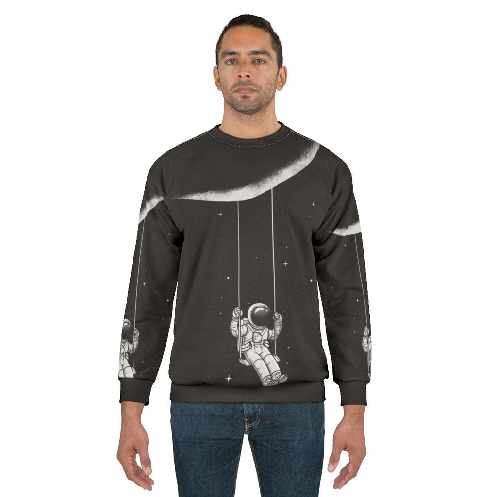 Astronomical moon swing sweatshirt with surreal, cosmic design