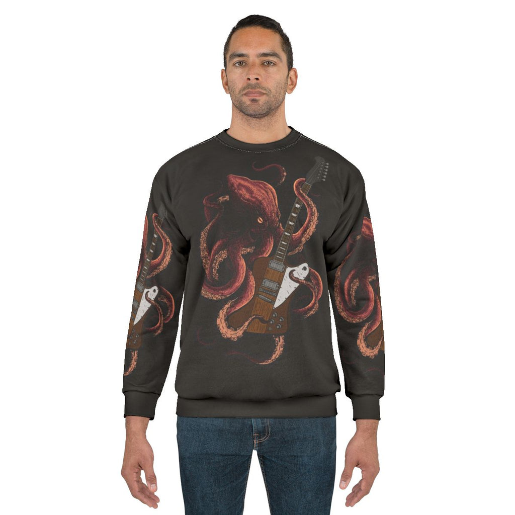 Octopus playing an electric guitar on a sweatshirt