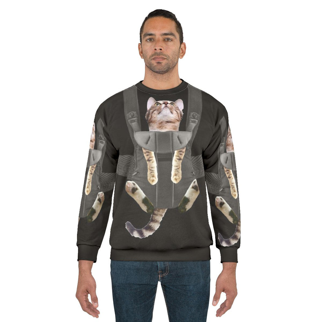Tabby cat in a baby carrier printed on a comfortable sweatshirt