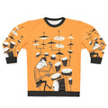 A person wearing a sweatshirt with a graphic design of drums and the text "Play That Beat"