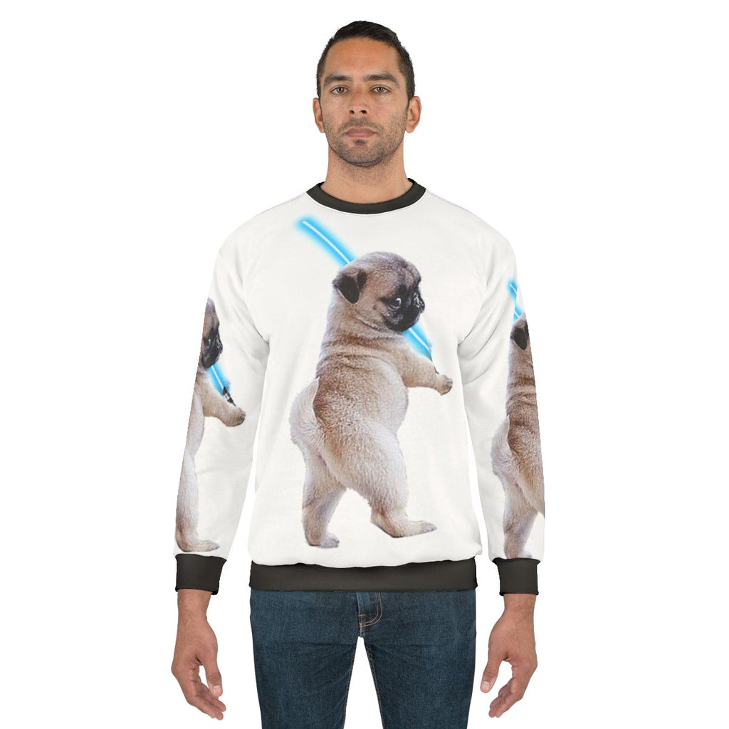 Pug wearing a sweatshirt with a lightsaber graphic