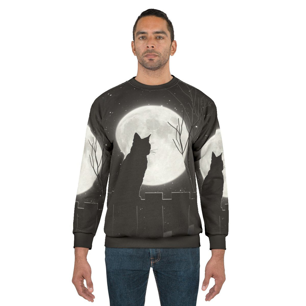Silent night cat looking at the full moon on a sweatshirt