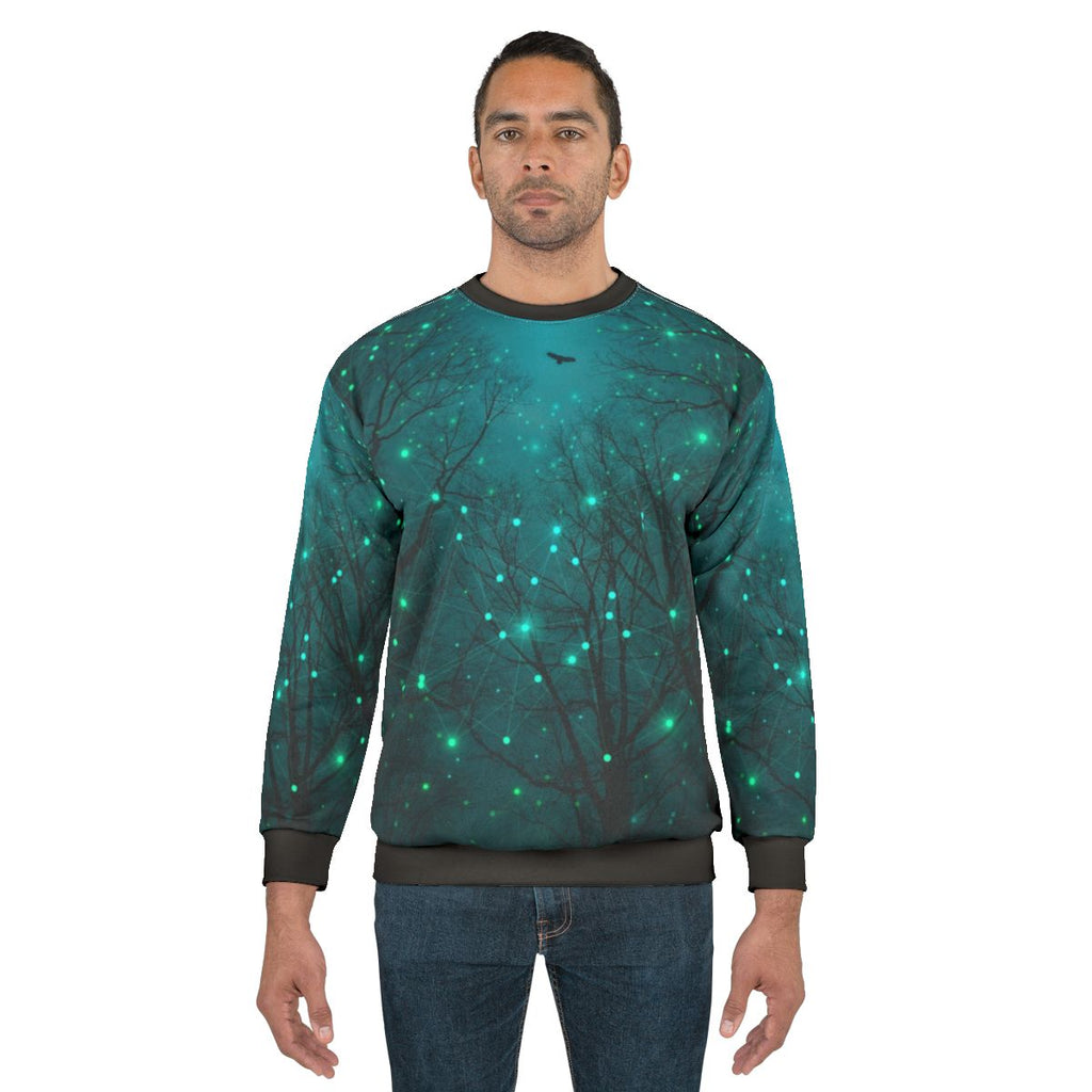 Glow-in-the-dark teal galaxy sweatshirt with geometric star pattern