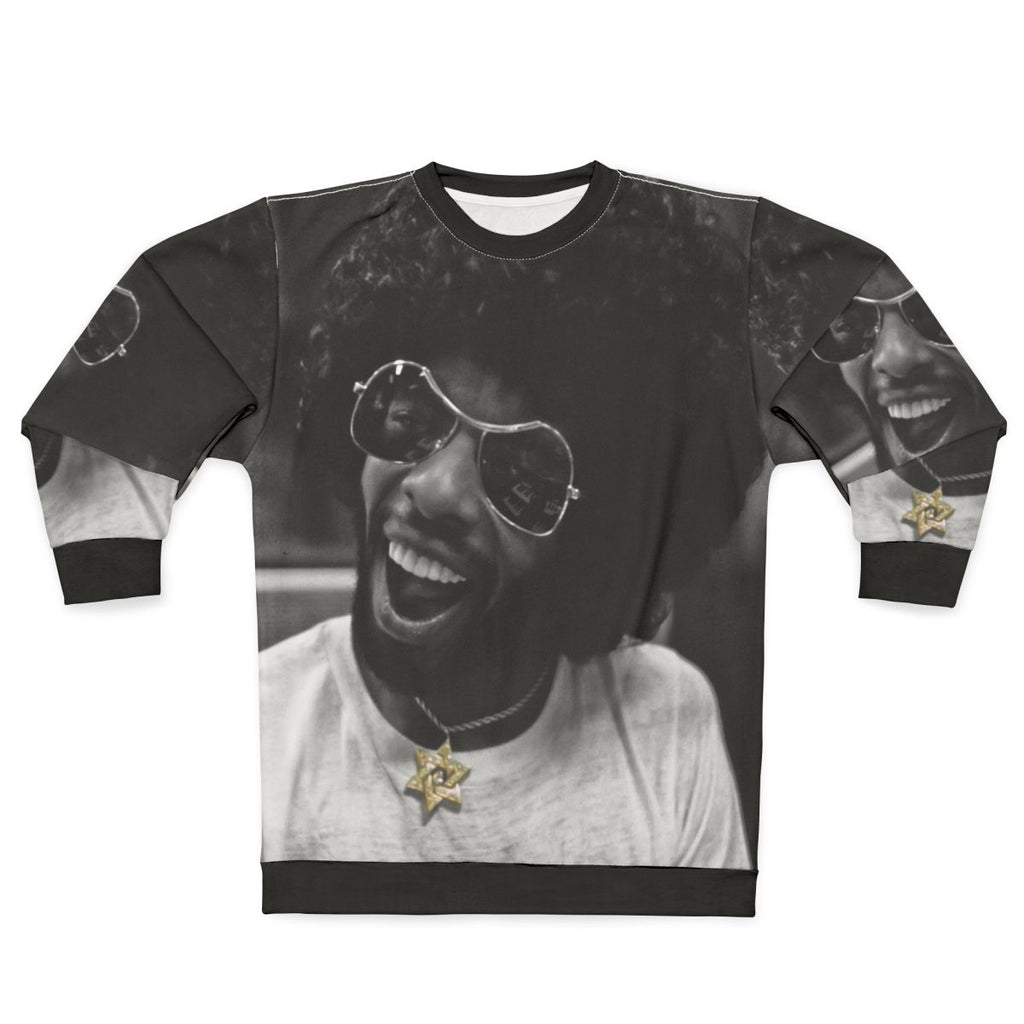 Sly Stone recording in the studio wearing a black and white sweatshirt