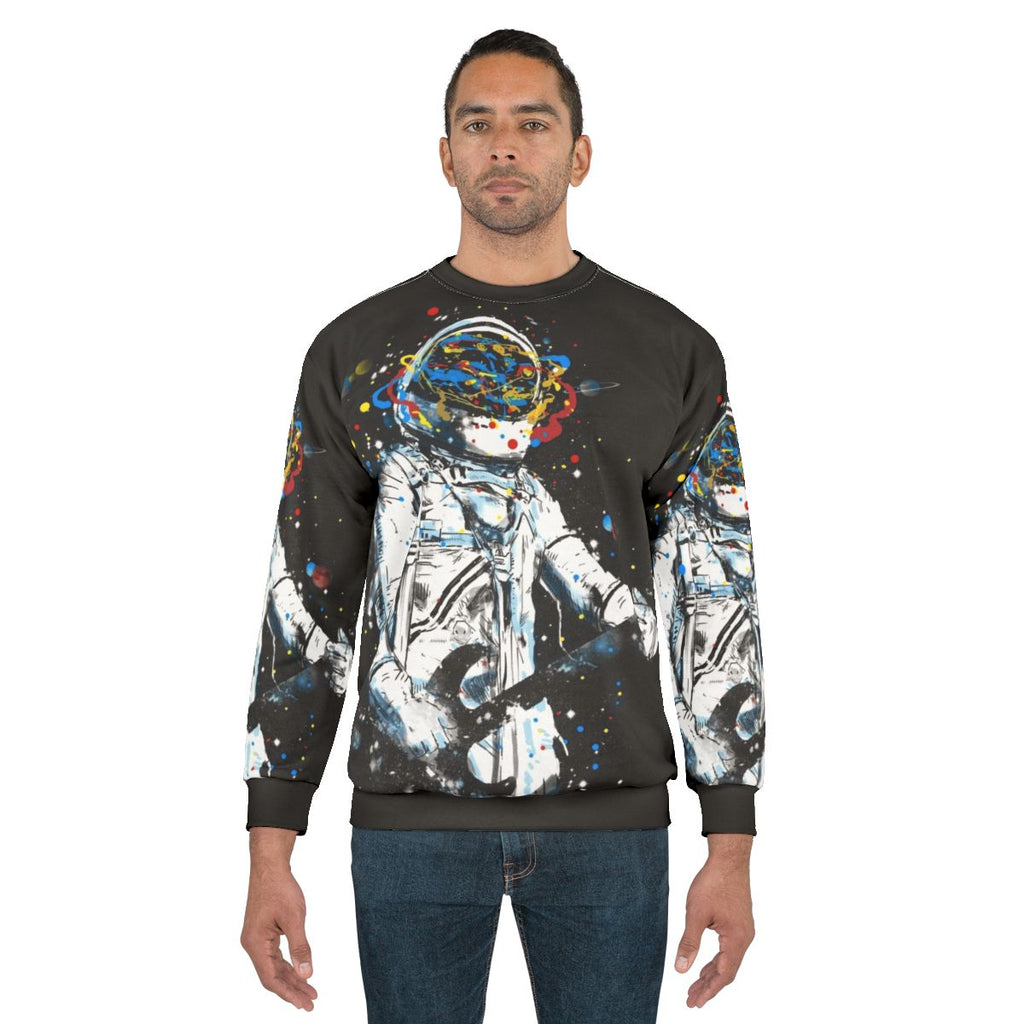 Cosmic Guitar Sweatshirt featuring an astronaut playing an air guitar in space