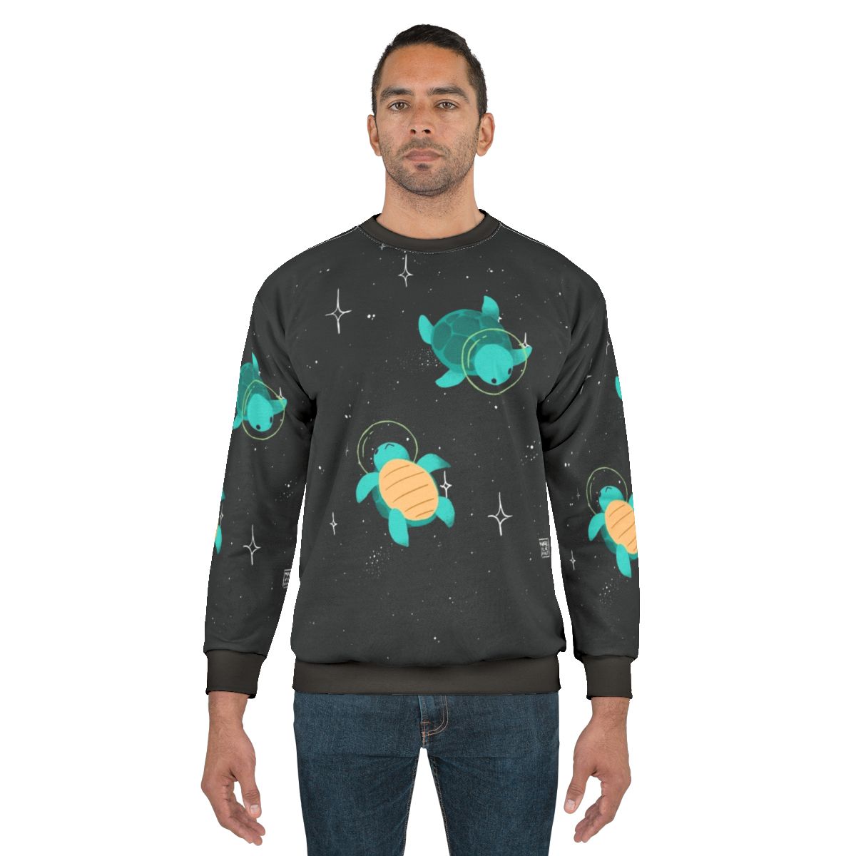 A sweatshirt featuring a playful space turtle design with stars and planets