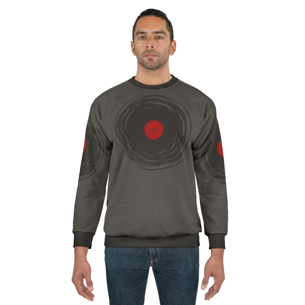 Spinning vinyl record graphic on a grey sweatshirt