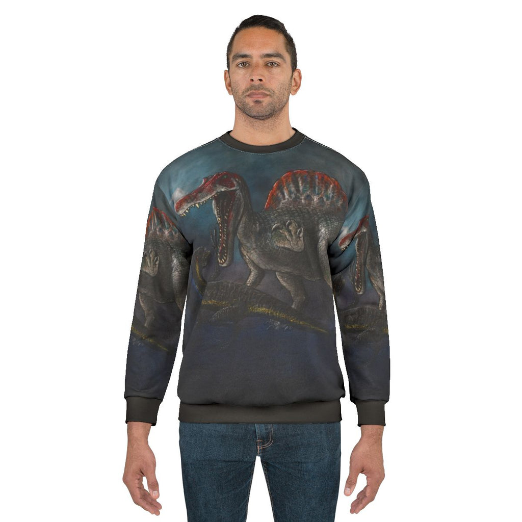 Spinosaurus vs Indominus Rex dinosaur battle graphic on a sweatshirt