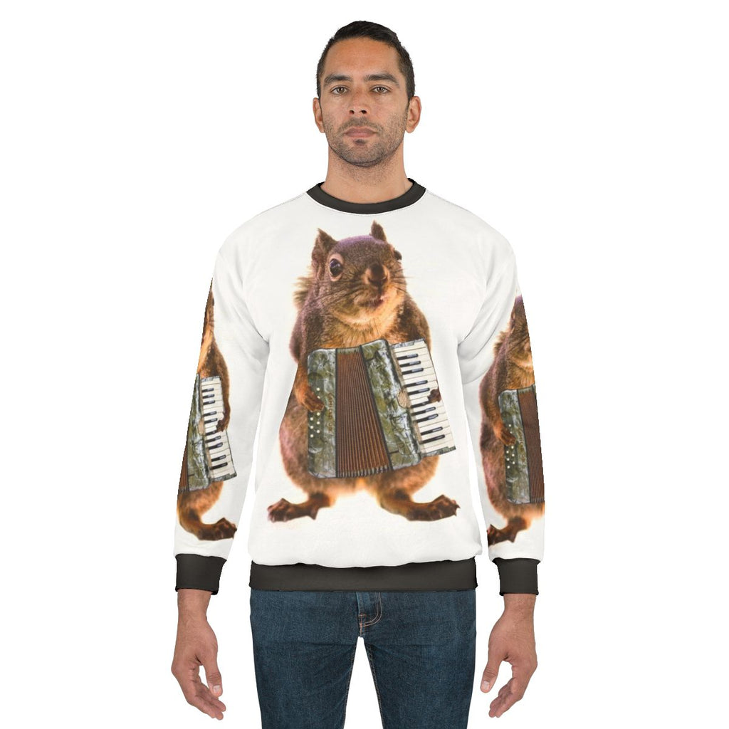 Squirrel playing an accordion on a sweatshirt