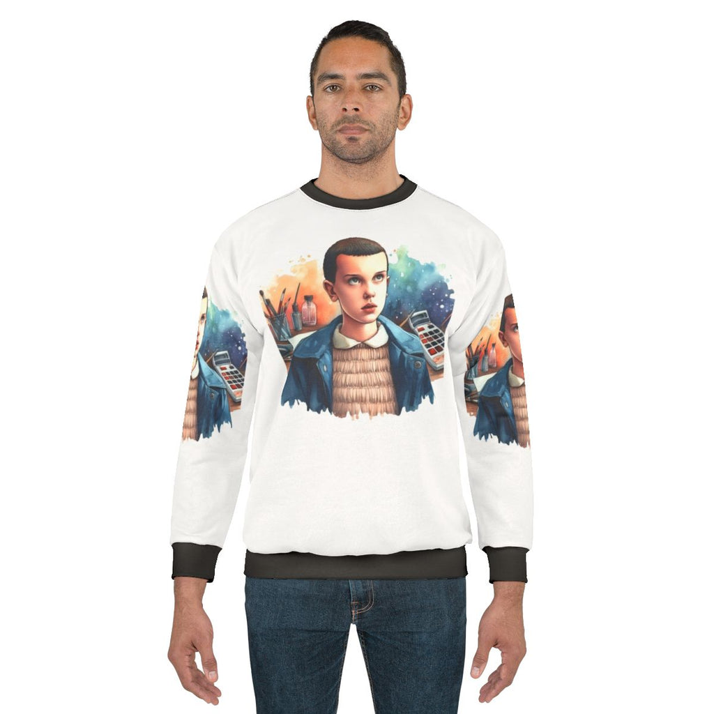 Eleven from Stranger Things wearing a cozy sweatshirt