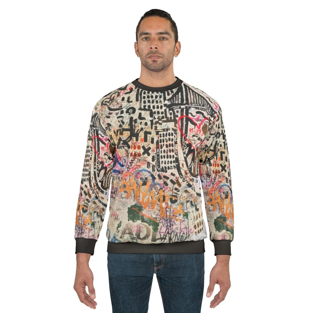 Street art inspired sweatshirt featuring Banksy-style graffiti design