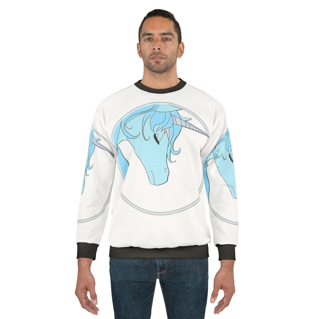 Model wearing a cozy "The Last Unicorn" sweatshirt with a magical unicorn design