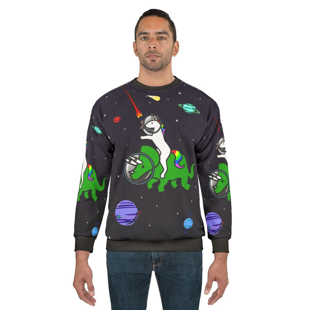Unicorn riding a triceratops in a space themed design on a sweatshirt