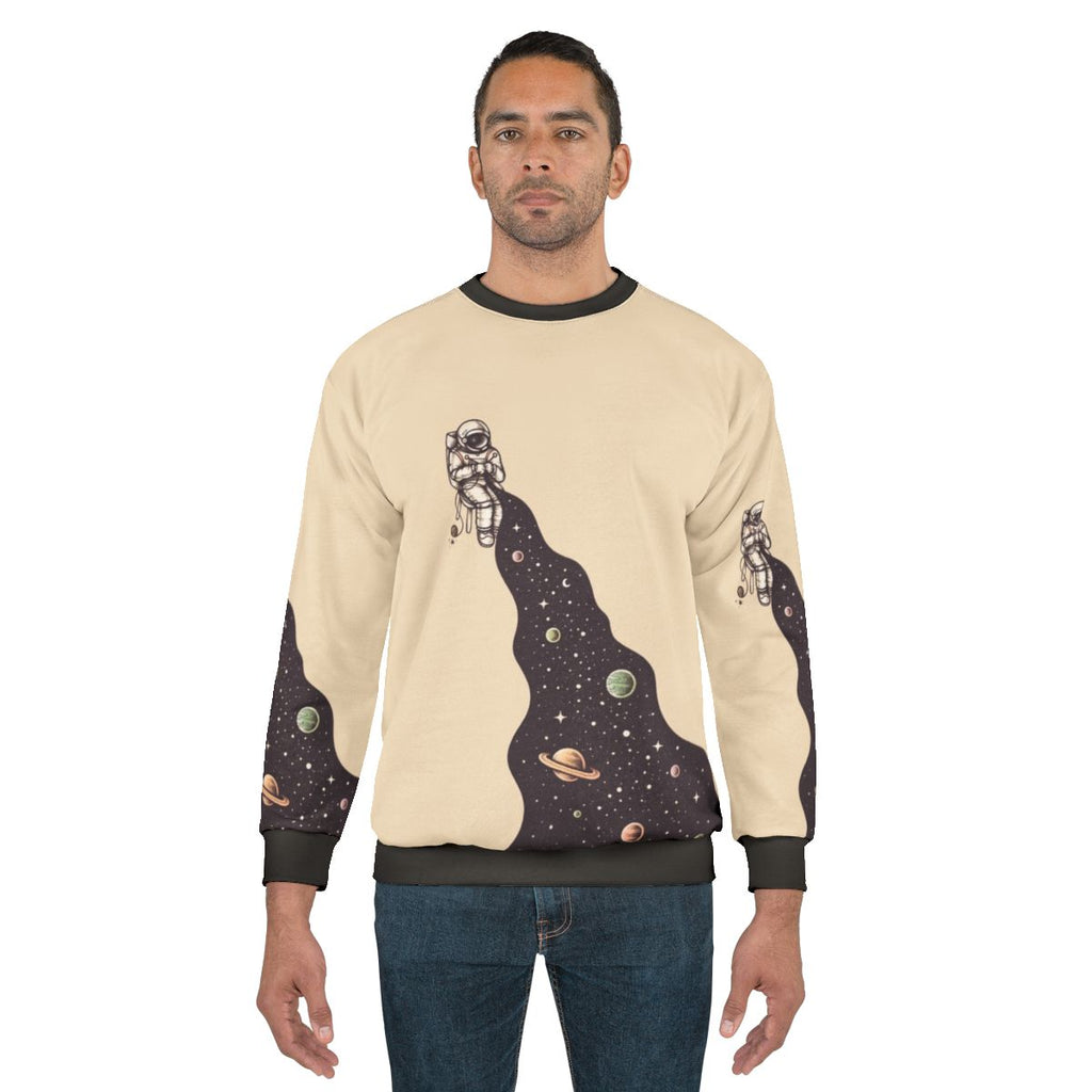 Cosmic universe knit sweatshirt with stars, planets and galaxy design