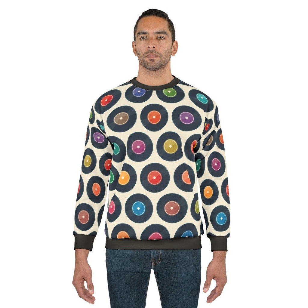 Vintage-style sweatshirt featuring a collection of classic vinyl records