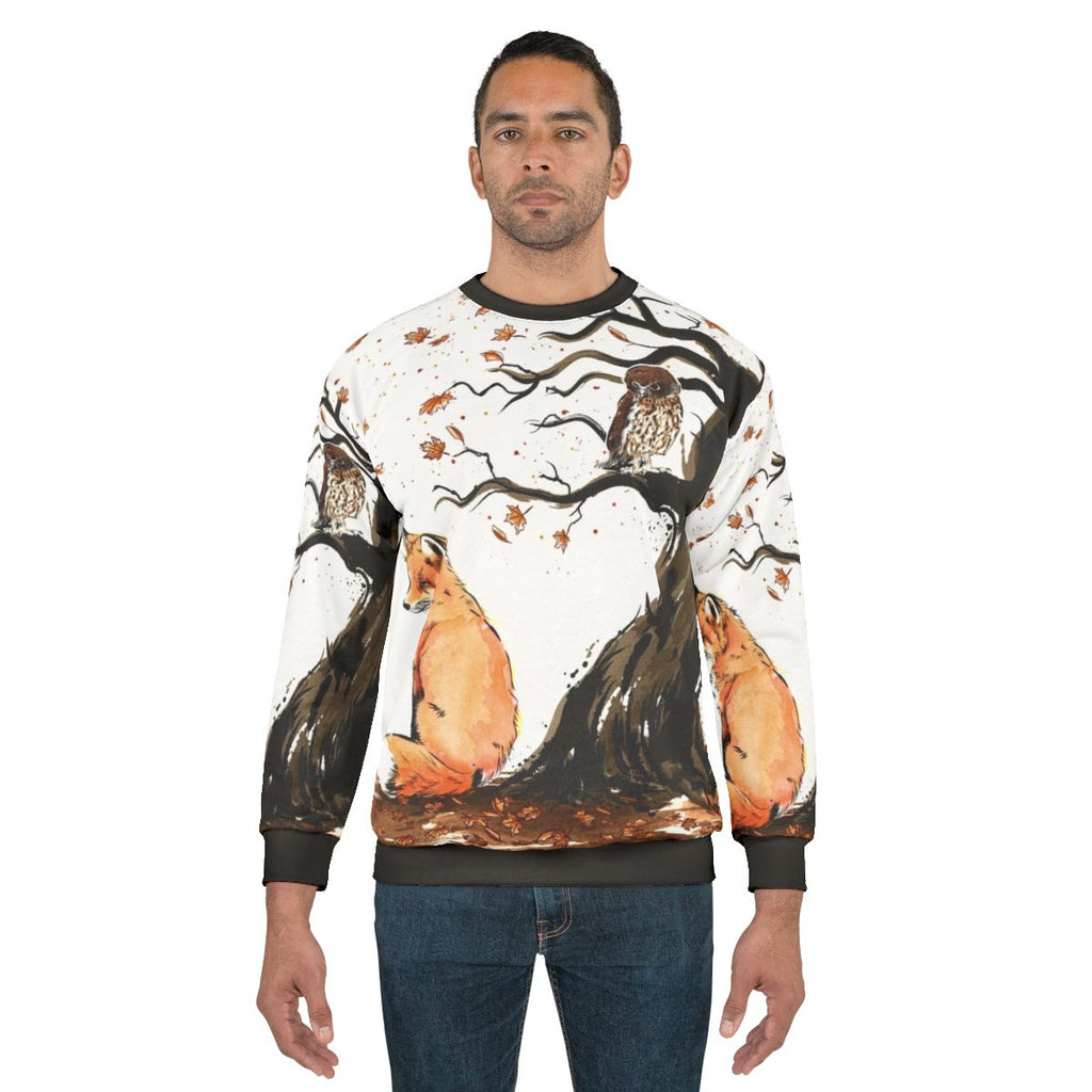 Watercolor illustration of a red fox and owl on an autumn sweatshirt