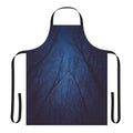 An abstract tree silhouette design against a dark, starry night sky and galaxy print background on an apron.